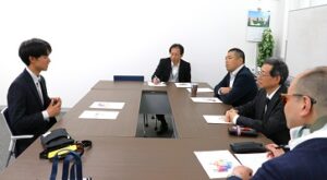 理事らに説明をする修了生